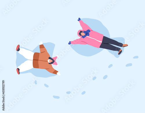 Happy family making snow angels together, lying, top view. Funny winter activ...