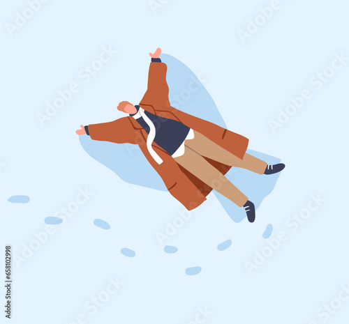 Man making snow angel print in snowdrift on winter holiday. Happy guy in coat...