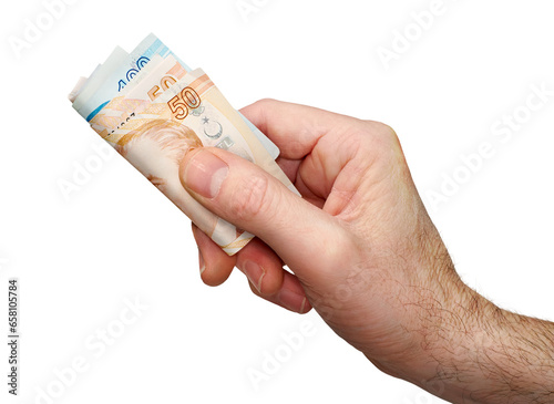 A hand holding, giving or paying Turkish Lira in 50 and 100 banknotes, paper currency, isolated against a transparent background. photo