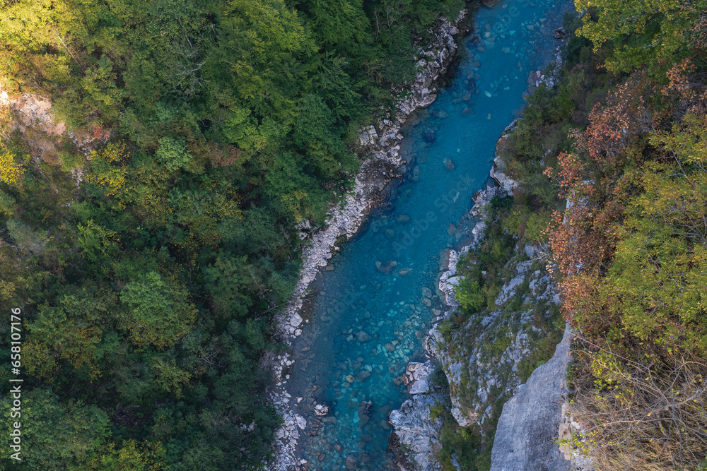 Amazing aerial shot of beautiful blue river. Forest and mountains background.
