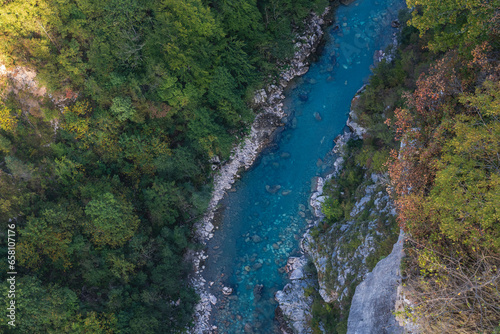 Amazing aerial shot of beautiful blue river. Forest and mountains background. © olezzo