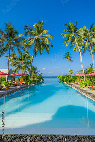 Stunning landscape, swimming pool sunny blue sky. Tropical resort hotel in Maldives. Fantastic relax peaceful vibes, leisure wellbeing chairs umbrella palm leaves. Luxury travel vacation destination