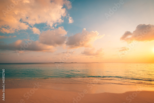 Closeup sea waves sand beach. Panoramic beach landscape. Inspire tropical coast seascape horizon. Stunning sunset sunlight colors  tranquil peaceful sky calm water. Happy positive vacation travel mood