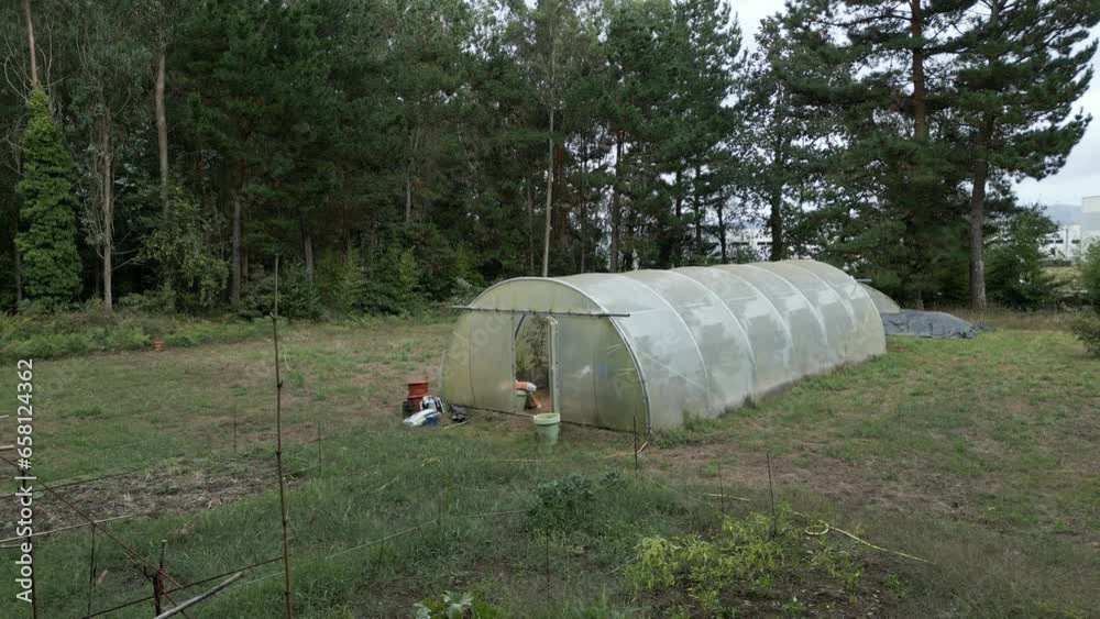 Large farming greenhouse manufactured from plastics. Farmland scene Large farming greenhouse manufactured from plastics. Farmland scene