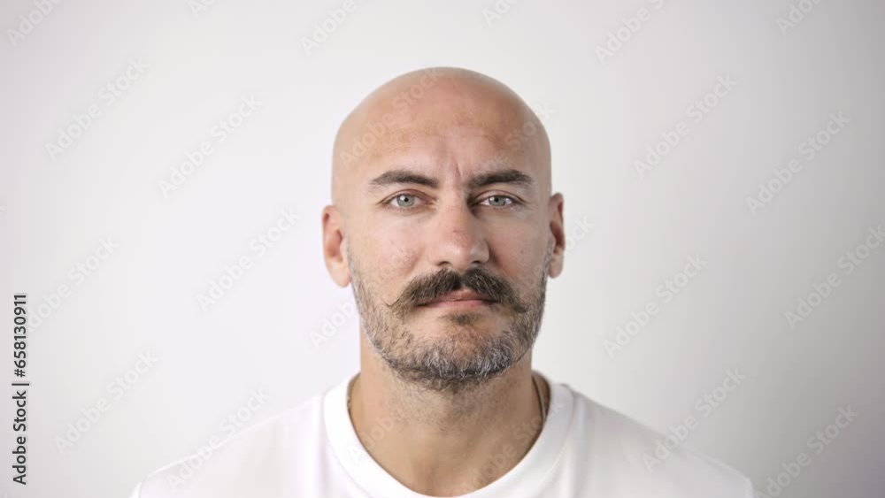 Handsome person look at camera close up. Young adult man face portrait. Stylish 30s guy on isolated white background. Attractive male model. Modern millennial people. Brutal bearded style. Barber shop