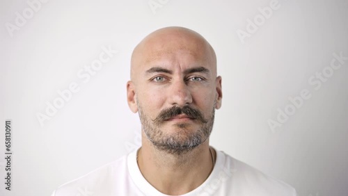 Handsome person look at camera close up. Young adult man face portrait. Stylish 30s guy on isolated white background. Attractive male model. Modern millennial people. Brutal bearded style. Barber shop