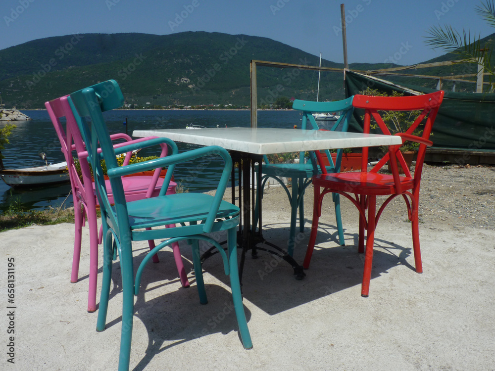 Colorful wooden chairs with view on sea