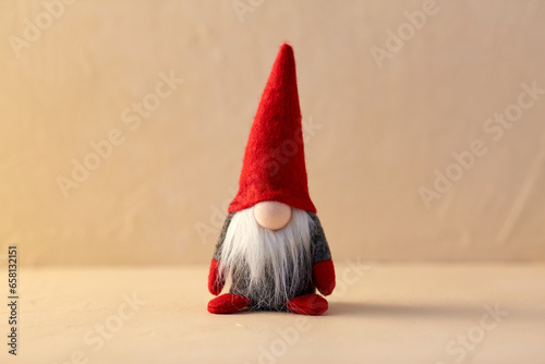 christmas, decoration and winter holidays concept - close up of gnome toy at home photo