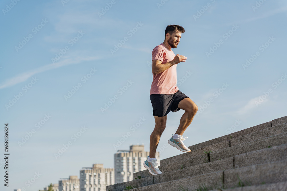 Fitness routine for cardio tolerance. A jogging guy in sportswear and full-length running shoes. A man training alone is an active and healthy lifestyle motivation. Fitness routine for cardio tolerance. A jogging guy in sportswear and full-length running shoes. A man training alone is an active and healthy lifestyle motivation.