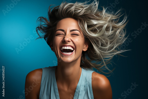 Vibrant middle-aged woman exuding joy and energy, twirling against a bright blue background.