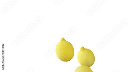Lemons falling down in slow motion on white background.