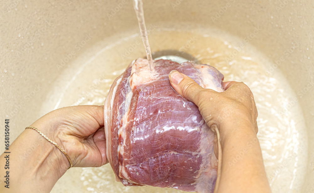 Fototapeta premium Female hands washing meat