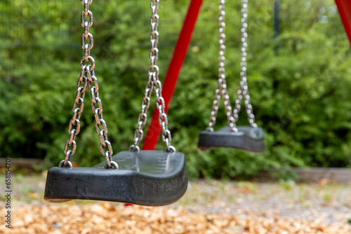 close up of empty swings at playground