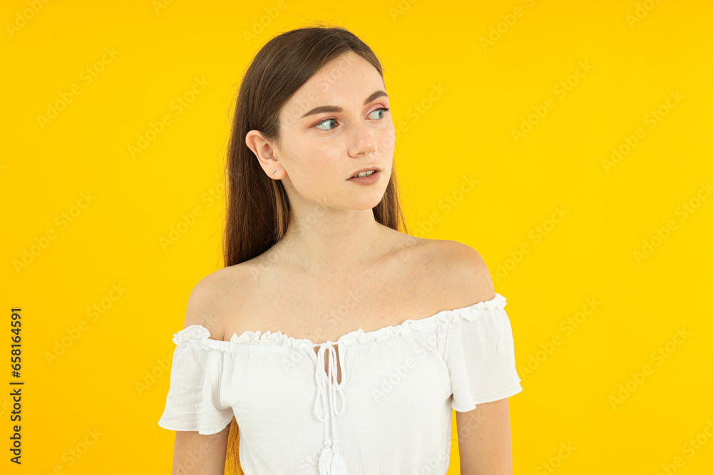 Obraz premium Beautiful emotional girl on a yellow background.