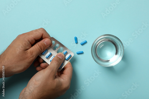 Blue viagra pills in a man's hand photo