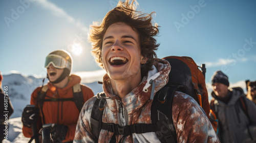 Portrait of a young man and his friends walking up a ski slope laughing and enjoying the moment © Paula