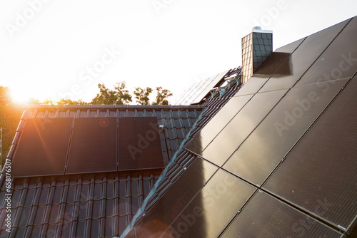 Solar panels on the roof of a sustainable single-family house at sunset