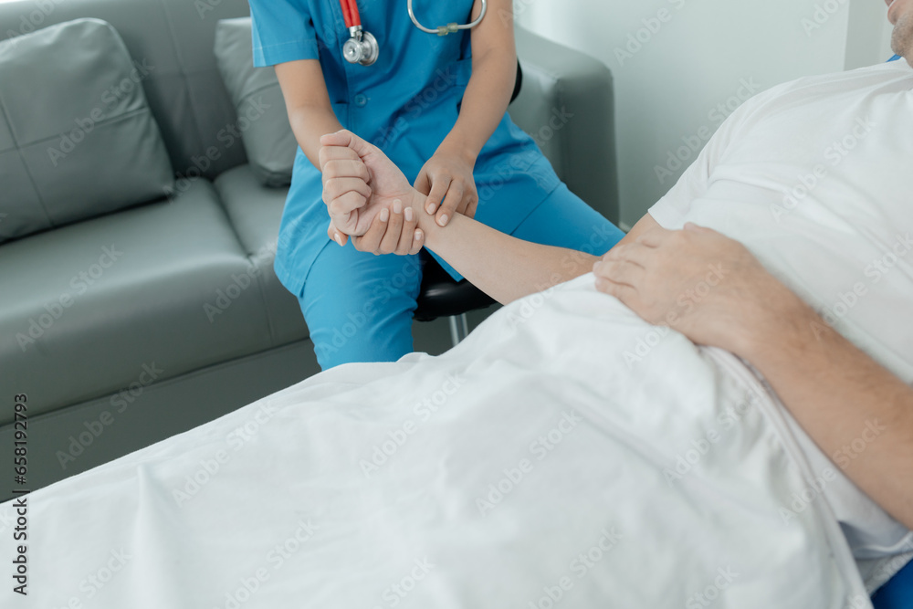 Patient on an inpatient hospital bed with a doctor examining and asking for information about the symptoms in order to diagnose the correct and appropriate treatment. The concept of medical treatment. Patient on an inpatient hospital bed with a doctor examining and asking for information about the symptoms in order to diagnose the correct and appropriate treatment. The concept of medical treatment.