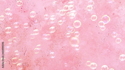 Soap bubbles on pink background