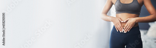 Heart hands, mockup and stomach of woman with gut health, diet or detox results at gym for wellness or training. Weight loss, abdomen and female athlete at a fitness center with finger frame for care