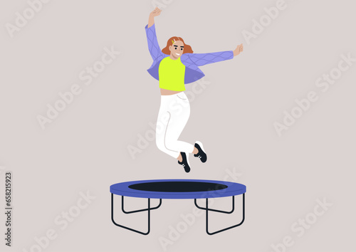 A joyful young woman in a quilted jacket adorned with wave patterns, jumping with her arms raised high above her head on a trampoline
