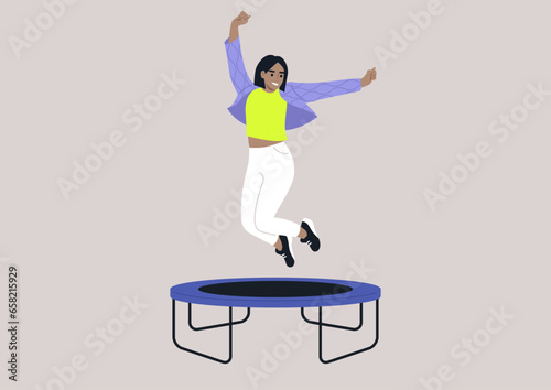 A joyful young woman in a quilted jacket adorned with wave patterns, jumping with her arms raised high above her head on a trampoline