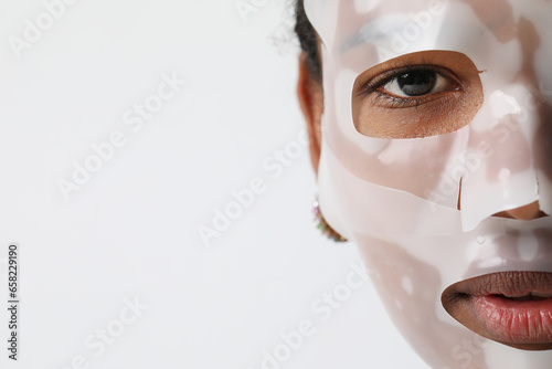 Close-up portrait of woman applies a hydro gel face mask. Skin care treatments