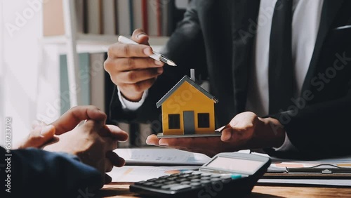 Real estate brokerage agent Deliver a sample of a model house to the customer, mortgage loan agreement Making lease and buy and sell house And contract home insurance mortgage loan concept