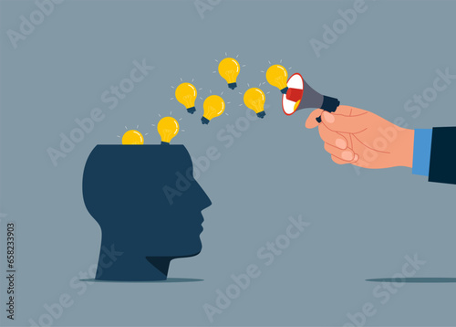 Hand holding a loudspeaker sending bulbs to head. Attracting attention. Modern vector illustration in flat style