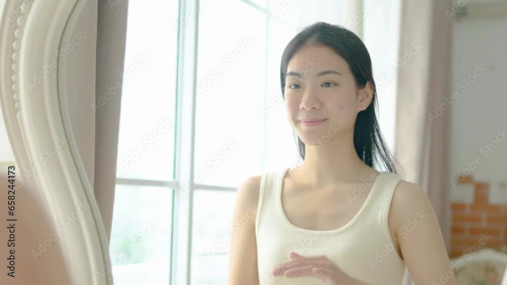 Slow motion portrait young asian woman uses creams on her face. Concept for fresh moisturized skin beautiful close up cosmetic face happy healthy model. Young black hair girl take care of her skin. Slow motion portrait young asian woman uses creams on her face. Concept for fresh moisturized skin beautiful close up cosmetic face happy healthy model. Young black hair girl take care of her skin.
