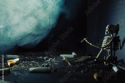 Human skeleton sits with a cigarette in a dark smoky room.