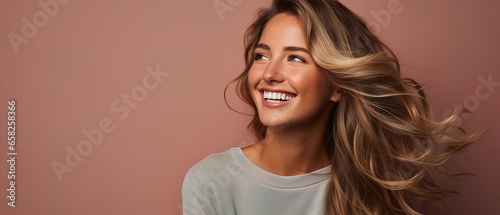 a young woman is smiling near solid background,, with empty copy space