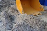 Photo of an excavator, a type of tractor that functions to excavate soil or lift objects embedded in the ground