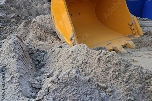 Photo of an excavator, a type of tractor that functions to excavate soil or lift objects embedded in the ground