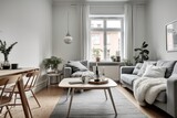 Stylish scandinavian living room with design furniture, plants, bamboo bookstand and wooden desk. Brown wooden parquet. Abstract painting on the white wall. Nice apartment. Modern decor of bright room