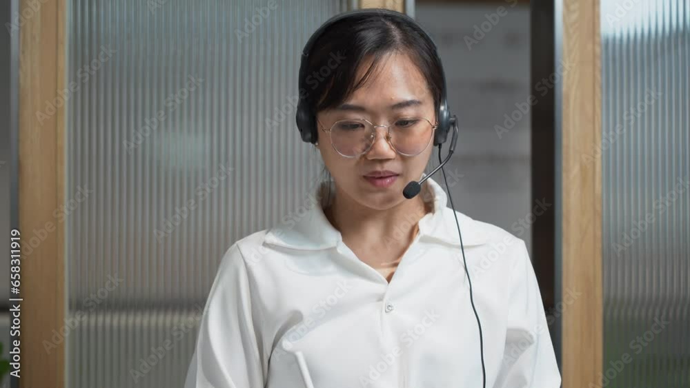 asian receptionist using headset. Customer service assistant working in office . call center asian receptionist using headset. Customer service assistant working in office . call center