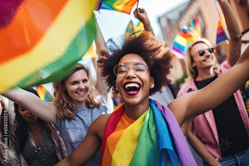 Group of friends celebrate gay pride with flags by dancing at a demonstration for support for equality