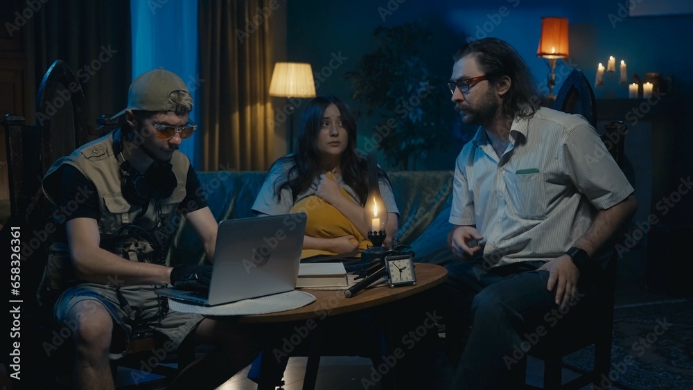 Medium-full photo capturing two ghost hunters and a victim sitting at the table. The woman is explaining what is happening in her house, asking for help. - obrazy, fototapety, plakaty 