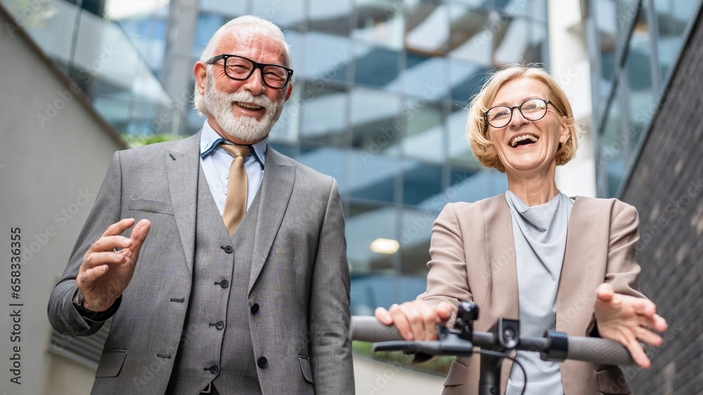 senior couple man and woman in front of modern building hotel senior couple man and woman in front of modern building hotel