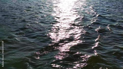 Sun glare on the waves of the water surface