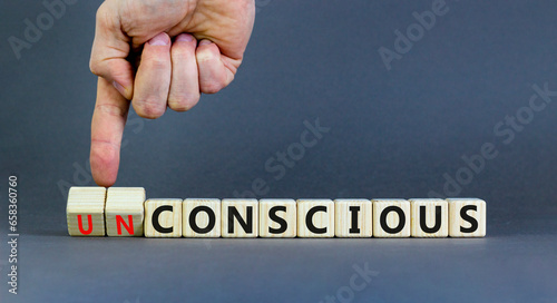 Conscious or unconscious symbol. Concept words Conscious Unconscious on wooden blocks. Beautiful grey table grey background. Psychologist hand. Psychology conscious or unconscious concept. Copy space.