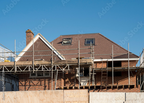 Europe, UK, England, Surrey, scaffolding on house roof renovation