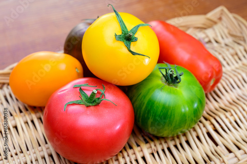 Variety of colorful tasty ripe french tomatoes on farmers market in Provence in summer close up photo