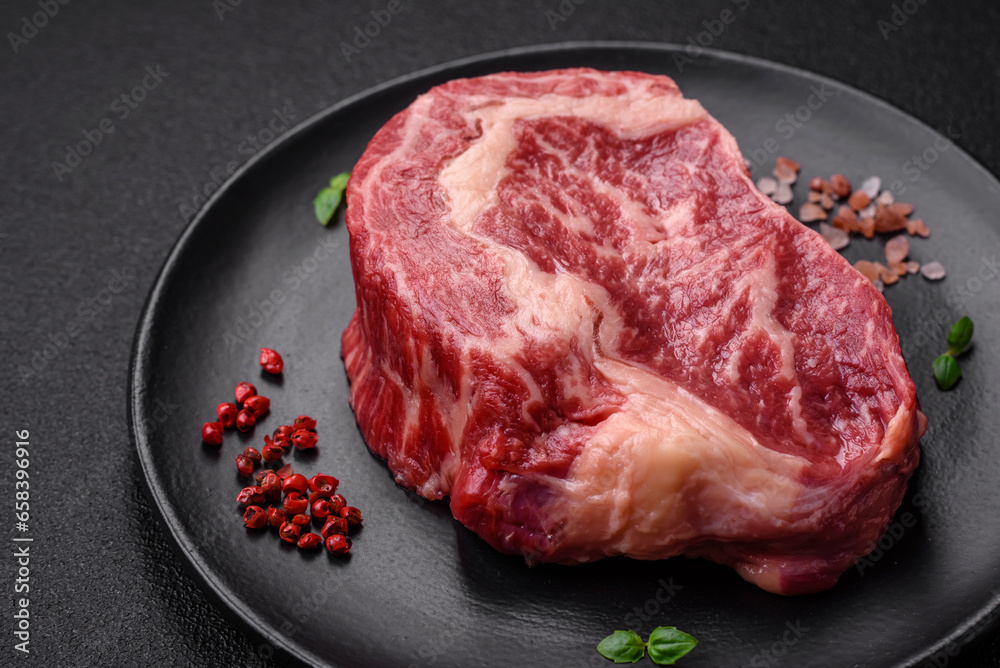 Fresh juicy raw beef striploin steak with salt and spices