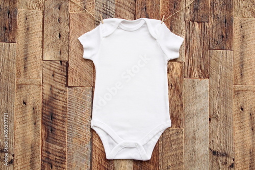 Baby onesie mock up . Blank bodysuit wooden wall	 photo