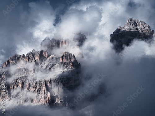 Rocky mountain peaks between clouds, Dolomites, Italy
