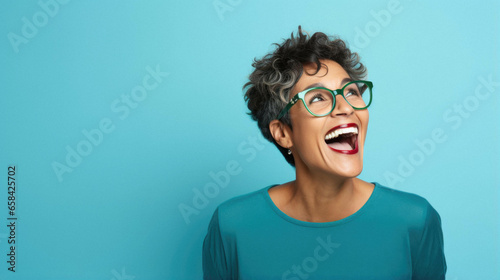 Middle age mature happy beautiful african american woman wearing casual clothes and glasses looking away with excited expression, cheerful and happy face. photo