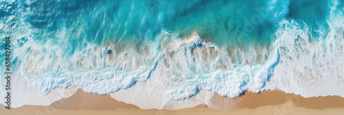 Drone perspective overlooking the clean and beautiful beach and waves