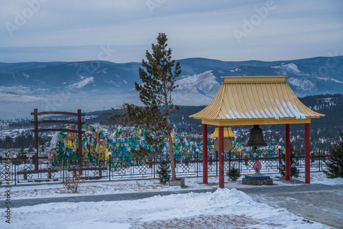 The traditional Buddhist bell on the territory of the Buddhist Temple of Rinpoche Bagsha during snowy winter in Siberian city of Ulan-Ude, Burtyatiya, Russia. photo