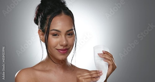 Pad, face and happy woman with feminine hygiene product, menstruation and wellness on grey background. Female health, reproductive and period presentation with sanitary napkin in portrait in studio